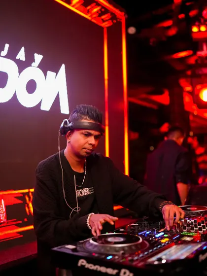 Another angle of me focused on the DJ controller. This highlights the technical side of mixing and beat-matching.