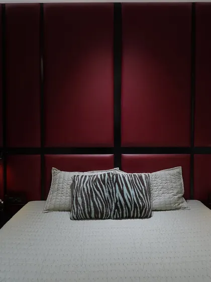 A front-on view of the red padded headboard, showing its symmetry and the integrated bedside lights.