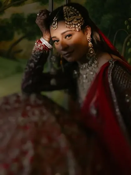 A quiet, painterly portrait of a bride, Angira, lost in thought before her ceremony. The soft lighting and rich background create a timeless, artistic feel that I love to explore in my bridal photography.
