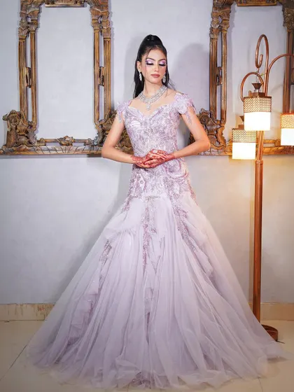 Another full-length view of the lilac gown, showing its delicate embroidery and modern design.