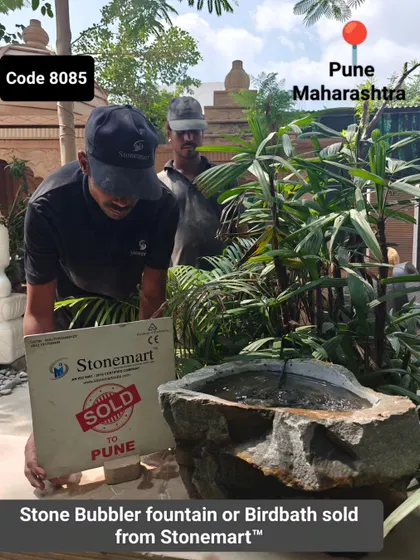 Another view of the stone bubbler fountain sold to Pune, highlighting its rugged texture.