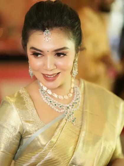 The gorgeous mom-to-be, Monica, looking serene and beautiful. Her makeup is soft and glowing, highlighting her features and complementing her traditional attire.