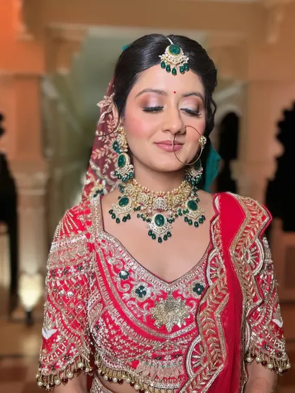 A radiant bride with her hair in a classic, neat bun. This timeless hairstyle is perfect for a traditional wedding look, ensuring all attention is on her beautiful smile and outfit.
