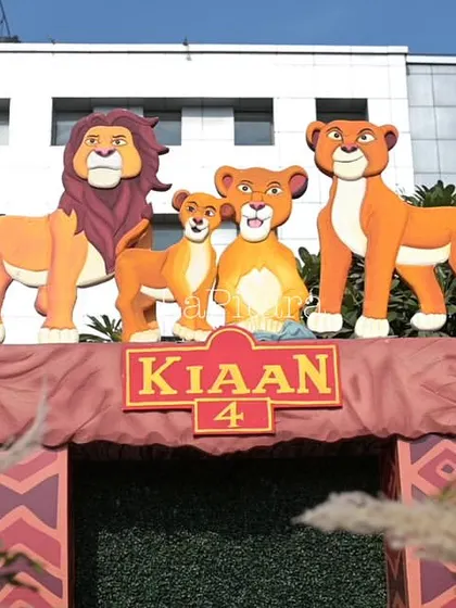 A close-up of the Lion King stage entrance, showcasing the detailed character cutouts of the royal lion family.