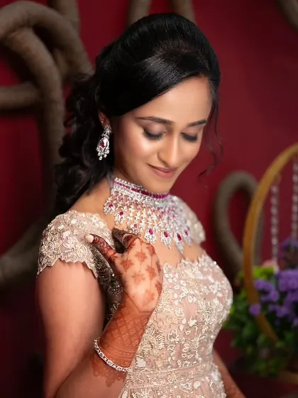 This artistic shot captures the elegance of a modern bride. The makeup is soft yet defined, with a focus on a flawless complexion and a subtle shimmer on the eyes, a popular request for reception events.