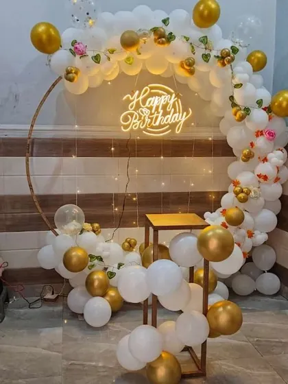 A simple and elegant white and gold balloon ring. This compact setup is ideal for smaller spaces, providing a beautiful backdrop for cake cutting and photos.
