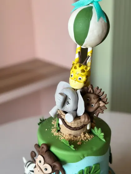 Welcome to the wild side! This jungle-themed cake is roaring with flavor, featuring adorable, handcrafted fondant animals like elephants, monkeys, and lions, perfect for a little explorer's party.