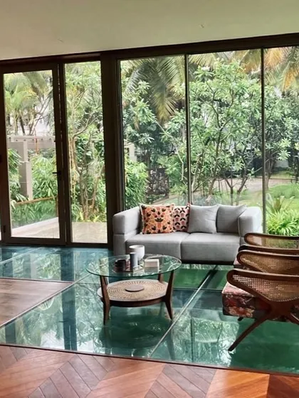 A unique living space featuring a glass floor that reveals a water body below. This design choice creates a surprising and delightful connection to the element of water, blurring the boundaries between the built and natural worlds.