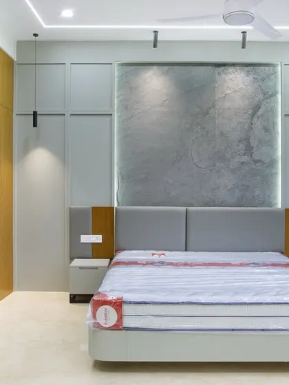 This view showcases the custom grey paneling that flanks the headboard, which cleverly conceals hidden storage. It’s a perfect example of how I merge function with form for a streamlined look.