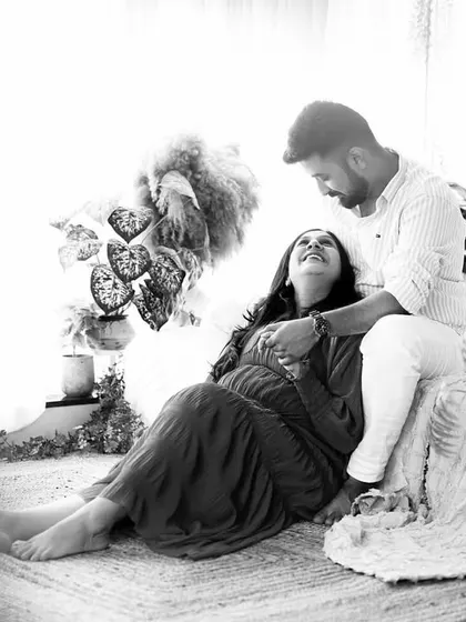 A candid black and white shot of the couple laughing together, showing the fun and relaxed nature of our photoshoots.