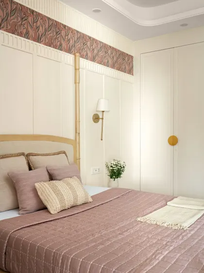 A close-up of the bedding, showing the rich textures and soft colors that define this room. The design is high-end, yet deeply personal.