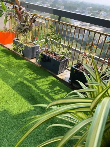 A view across a freshly installed artificial grass lawn on a high-rise balcony. The vibrant green turf provides a soft, clean surface and a welcome touch of nature with a city view.