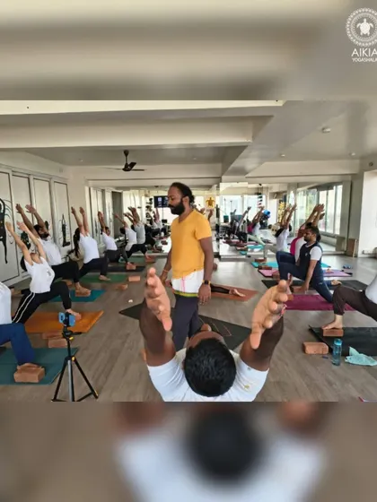 A guru's guidance is central to our teaching. Here, Surya Sir leads a class, ensuring every student's alignment and energy is focused, whether they are in the shala or joining online.
