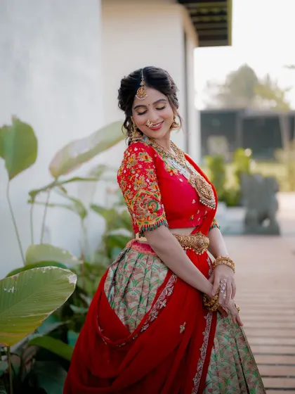 A candid, happy moment. The bride's natural smile and the way she adjusts her hair feel spontaneous and genuine, making for a beautiful portrait.