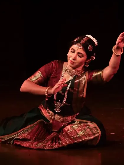 A seated expressive moment from the 'Soukariyam' performance. The floor is used extensively in Bharatanatyam to create different levels and dynamics in the choreography.
