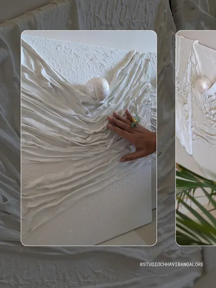 A close-up of the fabric texture art, where you can see the delicate folds and the way the light catches the single pearl.