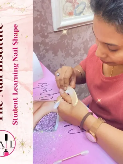 A student practices shaping a nail tip, learning how to create different styles like square, oval, and stiletto.