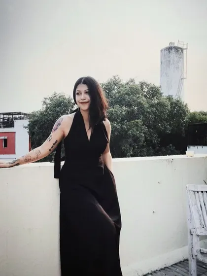 A self-portrait on my rooftop in a classic black dress from Doodlage. It’s about feeling good in what you wear, even in your own space.