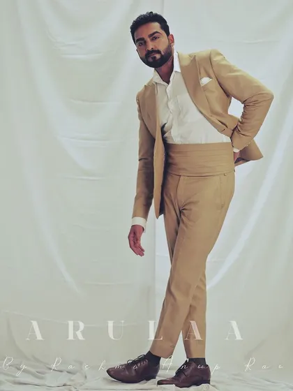 Actor Gagan Chinnappa looking sharp in the custom-tailored beige suit. This look includes a cummerbund, adding a touch of classic formalwear elegance to the modern silhouette.