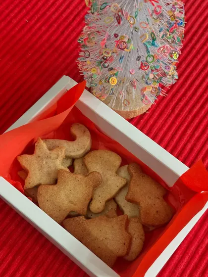 A box of our freshly baked, un-iced gingerbread cookies, shaped like stars, gingerbread men, and Christmas trees. These are included in our DIY kits or can be ordered on their own.