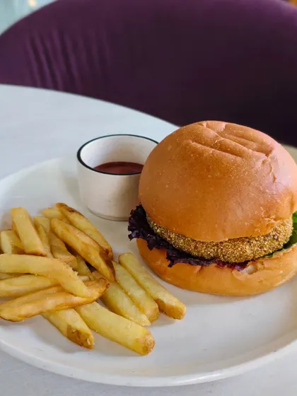 My veggie burger, featuring a crispy patty on a soft bun with fresh lettuce and a side of fries.