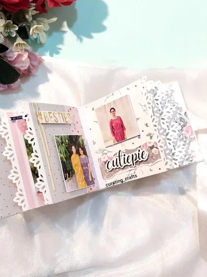 An inside page of the mini scrapbook, with delicate lace-cut edges.