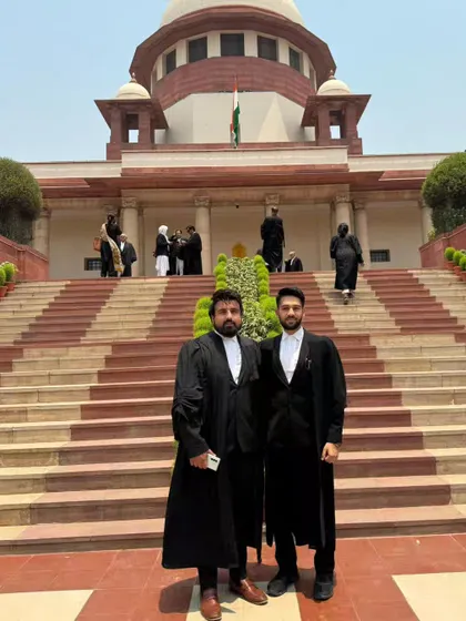Standing with a colleague outside the Supreme Court. I believe being a lawyer is a public trust, and I am committed to upholding the rights and liberties guaranteed by our Constitution.