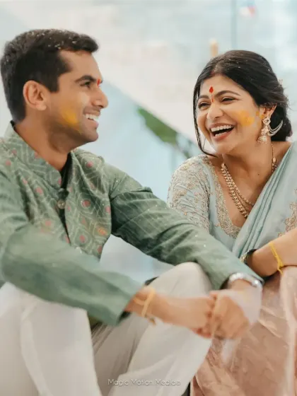 A couple shares a laugh during a relaxed moment at one of their pre-wedding events.