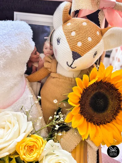 A detail shot from the Alia Bhatt hamper, showing the adorable deer plushie next to the personalized towel and fresh flowers.