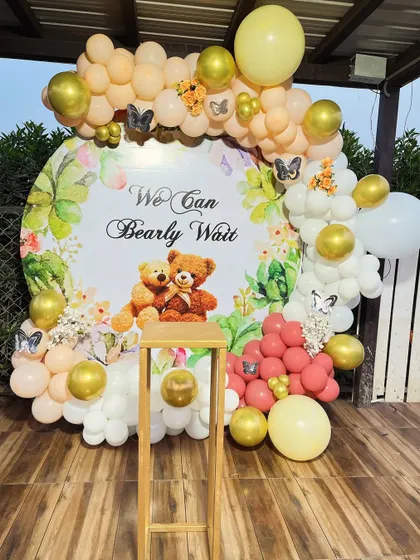 A sweet "We Can Bearly Wait" teddy bear themed baby shower with a custom backdrop and a pastel balloon arch.
