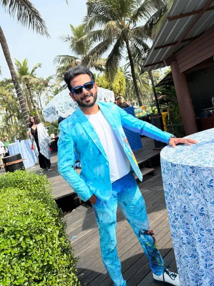 A custom-painted blue suit for a beach carnival in Goa. The outfit is designed to match the vibrant, artistic, and laid-back vibe of the location.