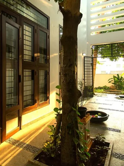 The courtyard acts as a transitional space, connecting the indoors with the garden beyond and allowing for natural cross-ventilation throughout the home.