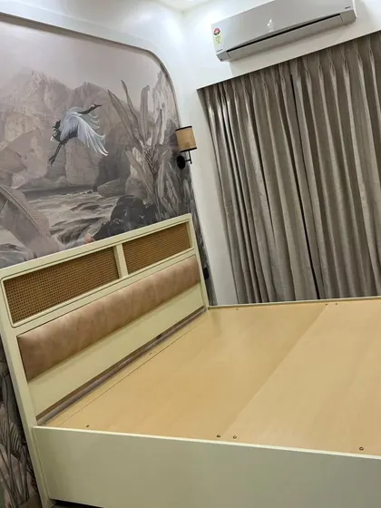 The master bedroom at our Mahagun Moderne project. The stunning wallpaper creates a feature wall behind the custom bed, which includes a cane and cushioned headboard.