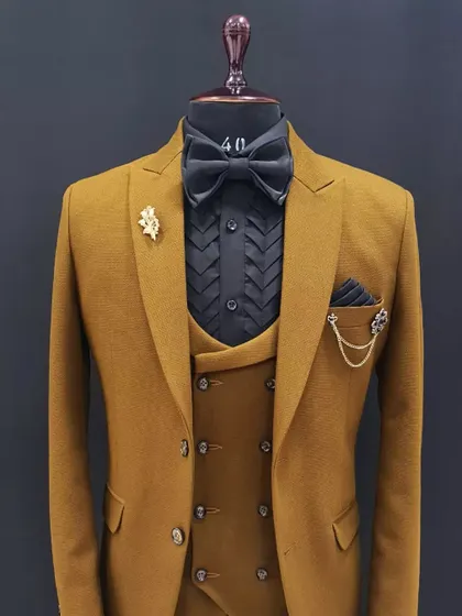 This mustard three-piece suit is styled with a black shirt and bow tie for a more formal, evening-appropriate look. It shows the versatility of a single suit when paired with different accessories.