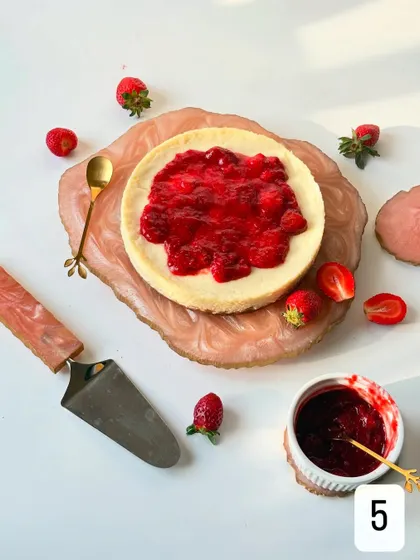 Here is the Baked Yogurt Cheesecake fully topped with my vibrant, fresh strawberry compote. The color and texture contrast beautifully with the smooth, pale cheesecake.
