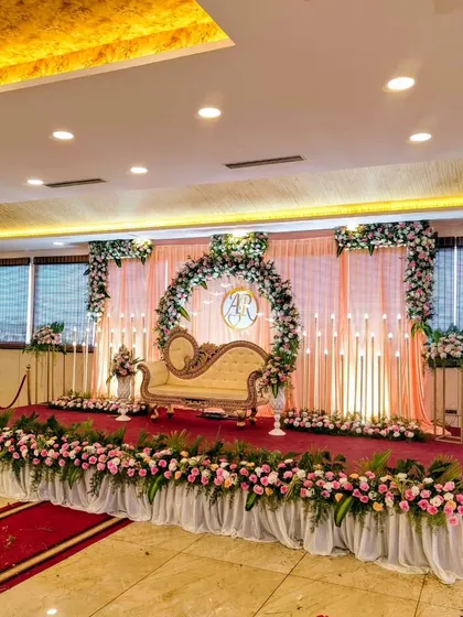 A full view of the elegant pink floral stage setup.
