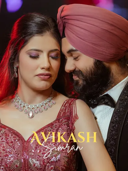 An intimate close-up of Avikash and Simran. The warm, dramatic lighting and their serene expressions create a powerful and emotional portrait.