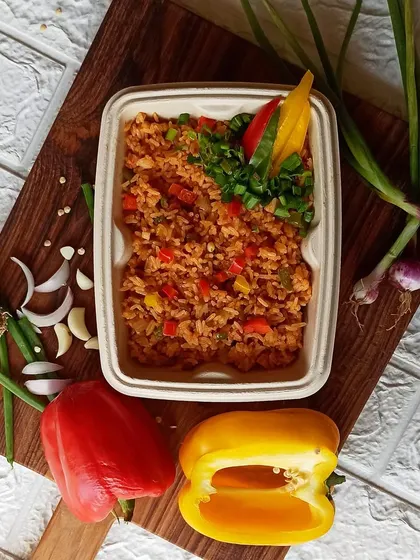 For those who like it spicy, my Schezwan Fried Rice is a perfect choice. It's tossed with colorful bell peppers, garlic, ginger, and a fiery Schezwan sauce, then garnished with fresh spring onions.