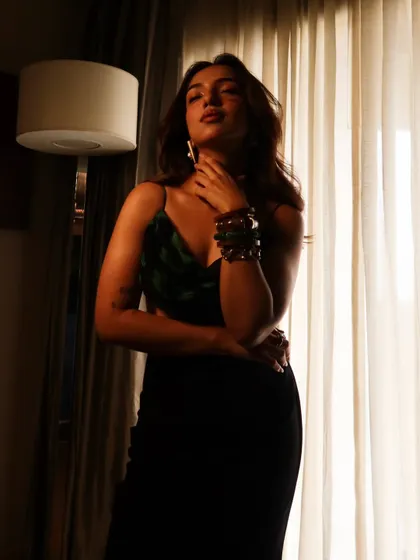 A moody, atmospheric shot of Ahsaas Channa for the 'Mismatched' promotions. The lighting and her pose create a sense of drama and intrigue.