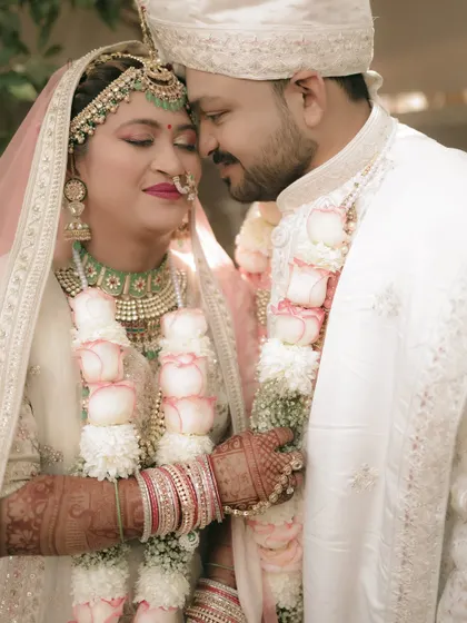 A tender embrace, capturing the beautiful details of the bride's jewelry and the couple's loving bond.