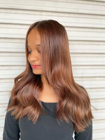 A beautiful example of the "Peanut Brown" color trend. This look is all about warm, toasty caramels with golden highlights for a natural allure.