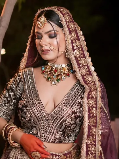 A beautiful pose showcasing the full bridal look in the wine-colored lehenga.