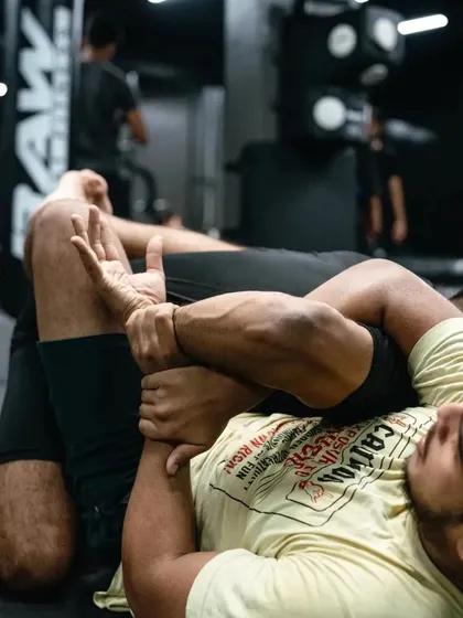 A close-up of a grappling exchange, showing the intricate hand-fighting involved in securing a submission.