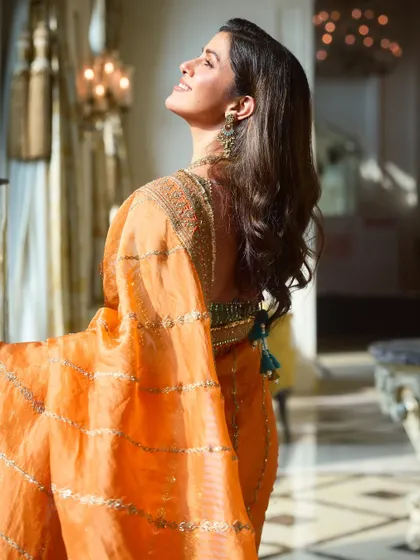 This profile shot highlights the beautiful contouring and the way the makeup complements the traditional jewelry and vibrant saree. It's all about creating a cohesive and stunning final image.