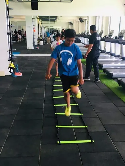 Consistency is key. Every drill, like this agility ladder exercise, is a step towards building lasting fitness habits and athletic confidence in a positive group setting.
