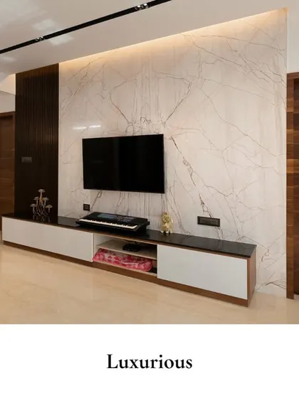 A luxurious TV unit wall featuring a large slab of marble, creating a dramatic and stylish backdrop. The sleek, low-profile console provides practical storage while maintaining a clean, minimalist aesthetic.