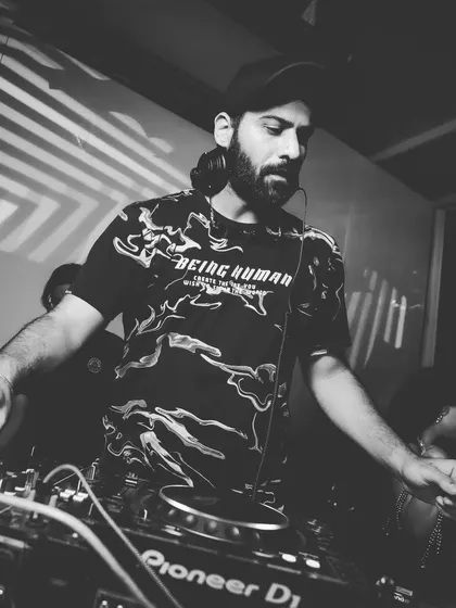 A black and white shot capturing the intensity of a late-night set. It's all about precision and feeling the music.