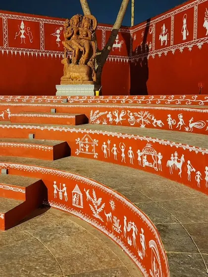 A daytime shot of the Warli art, highlighting the intricate patterns and the central sculpture.
