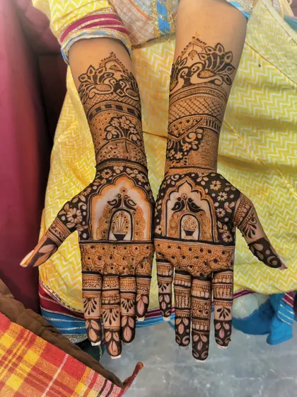 A special design for the groom's sister. This mehndi features beautiful peacocks and hanging bells, making her feel just as special on the big day.