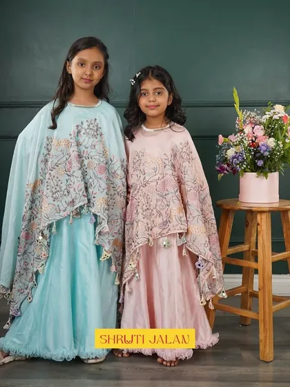 Another look at my cape sets, this time with two sisters posing beautifully. The soft blue and pink colors complement each other perfectly, making them a great choice for sibling photos.